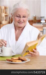 Elderly lady enjoying tea and biscuits