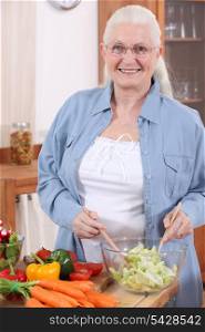 Elderly lady making a salad