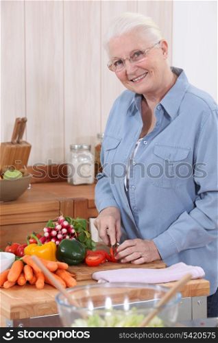 Elderly lady preparing vegetables