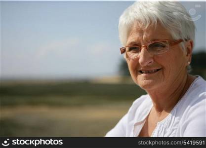 Elderly lady relaxing in the countryside