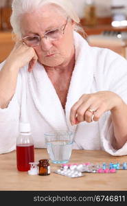 Elderly lady sat with her medication