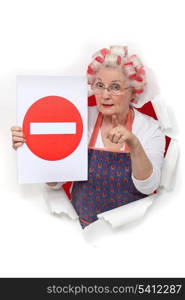 Elderly lady with hair rollers issuing warning