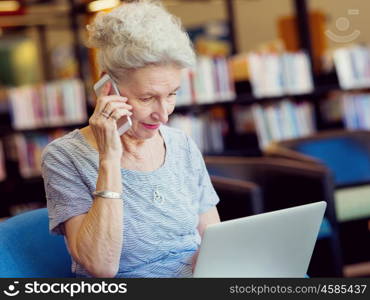 Elderly lady working with laptop. Learning new technologies