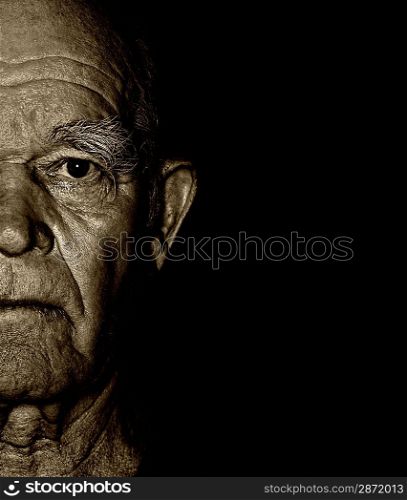 Elderly man&acute;s face over blask background