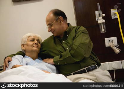 Elderly man comforts his wife