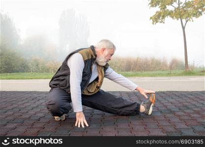 Elderly man doing physical exercise in the morning in park