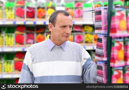 elderly man in shop of seeds