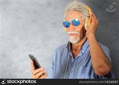 elderly man listen music with headphone