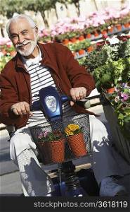 Elderly man on motor scooter in garden center