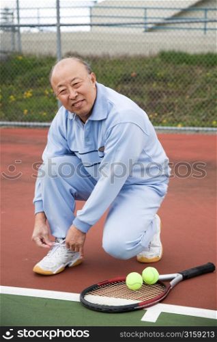 Elderly man playing Tennis