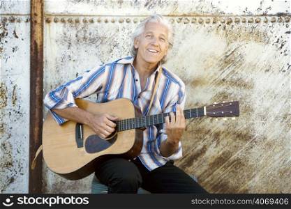 Elderly man playing the guitar