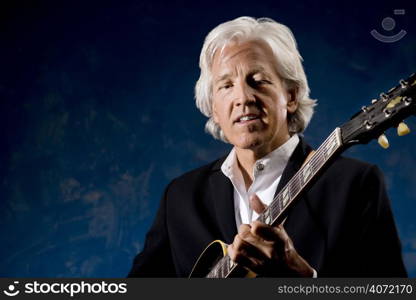 Elderly man playing the guitar