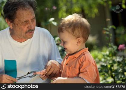 Elderly man playing with a child