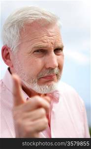 Elderly man shaking his finger in disapproval