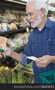 Elderly man shopping for vegetables