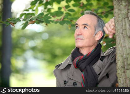 Elderly man strolling in the forest