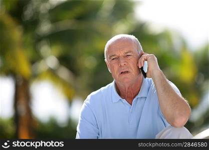 Elderly man talking on his mobile phone
