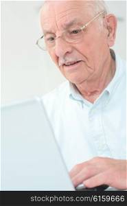 elderly man with a laptop
