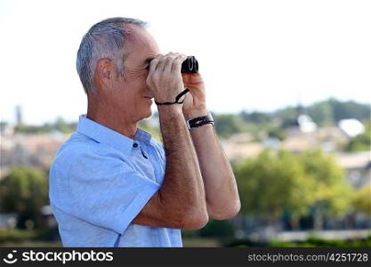 Elderly man with binoculars