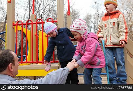 elderly man with children on playground