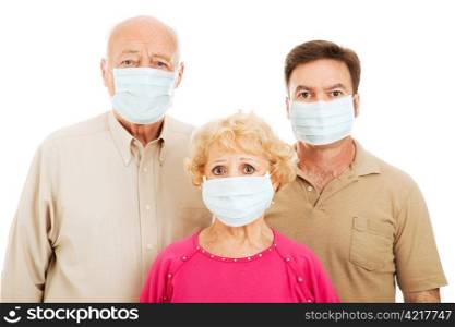 Elderly parents and their adult son wearing face masks to protect against a health care epidemic.