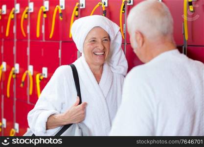 elderly people having a conversation in the spa locker
