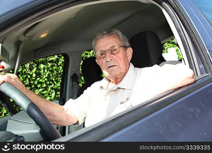 Elderly person driving a car