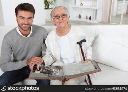 Elderly person looking at photos with son