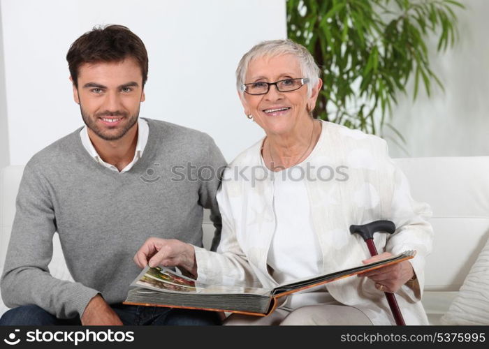 Elderly person looking at photos with son