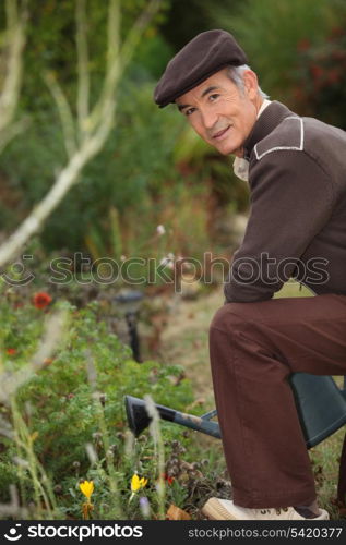 Elderly person watering flowers