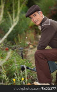 Elderly person watering flowers