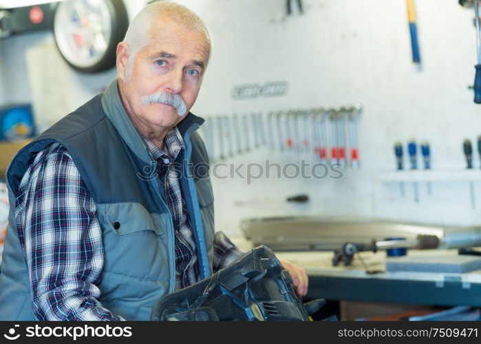 elderly shoemaker in his workshop