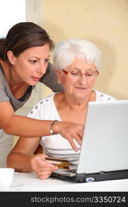 Elderly woman and young woman shopping on internet