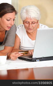 Elderly woman and young woman shopping on internet