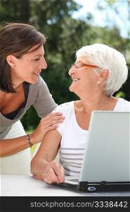 Elderly woman and young woman surfing on internet