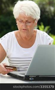 Elderly woman buying online