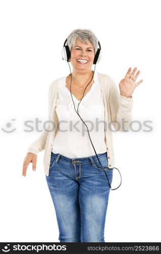 Elderly woman dancing while listen music with headphones, isolated over white background