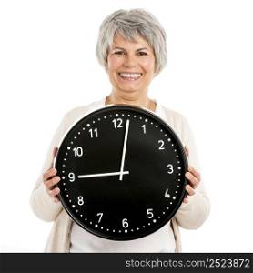 Elderly woman holding a clock, isoalted on white background