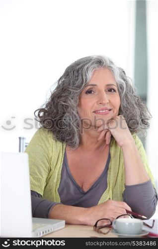 Elderly woman in front of her laptop