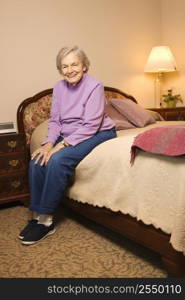 Elderly woman in her bedroom at retirement community center.