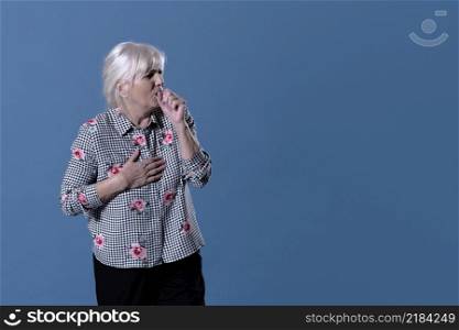 elderly woman is coughing