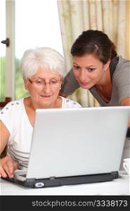 Elderly woman learning how to use computer
