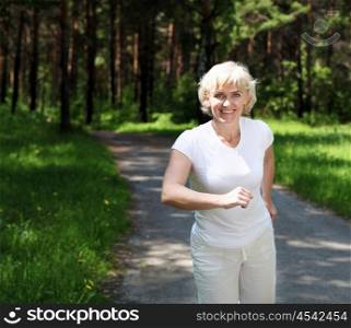 Elderly woman likes to run in the park. Healthy lifestyle