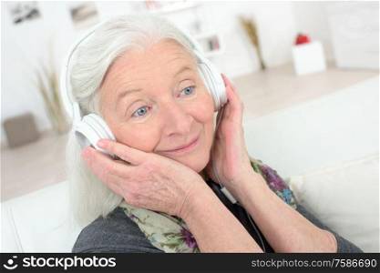 elderly woman listening through a headset