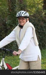 Elderly woman riding her bike