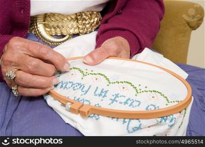 Elderly woman stitching