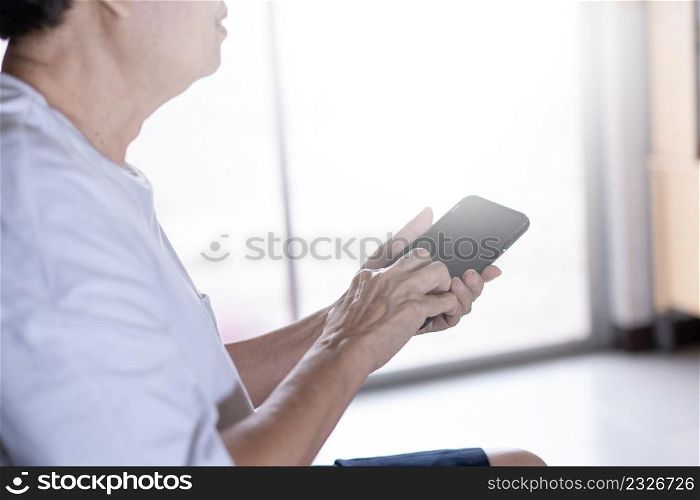 Elderly woman using her phone in home