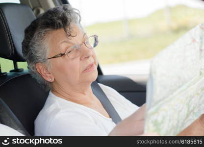 elderly woman with a map