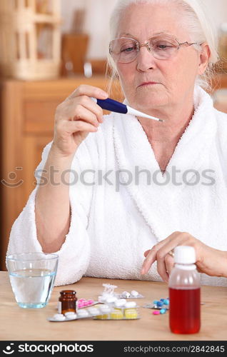 Elderly woman with a thermometer