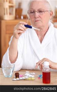 Elderly woman with a thermometer